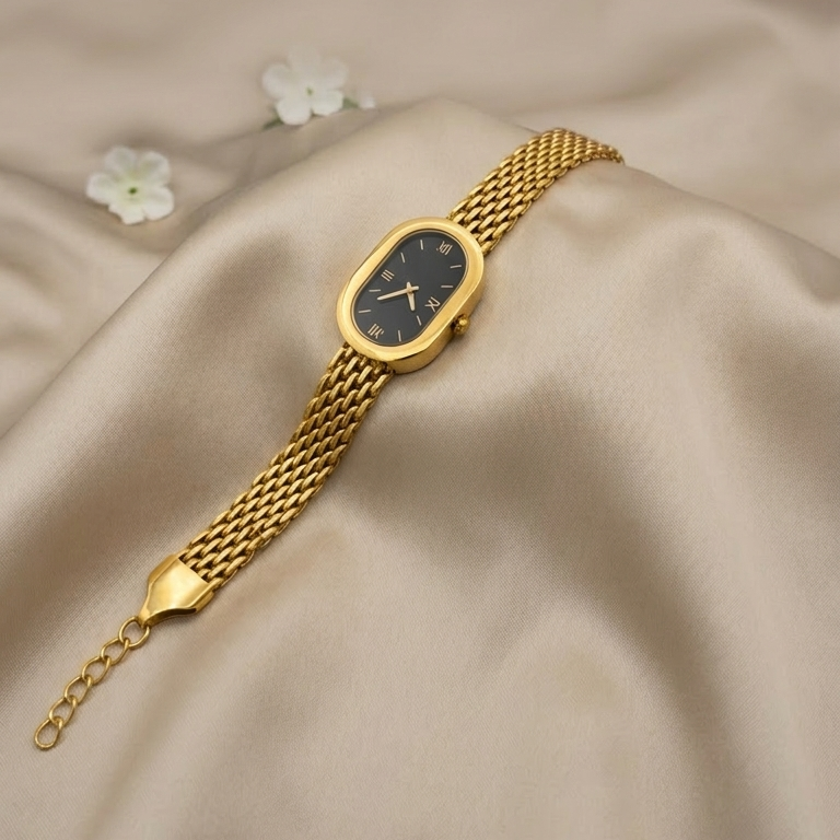 Gold bracelet watch on a beige fabric background