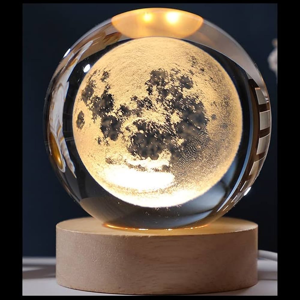 Moon-shaped lamp with wooden base on a dark background