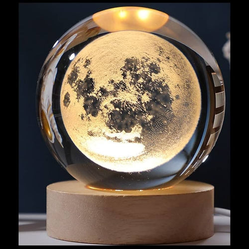 Moon-shaped lamp with wooden base on a dark background